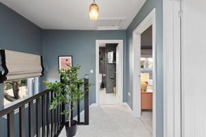 a hallway of a home with blue walls at Paradykes House in Loanhead