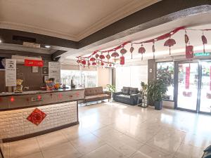 a restaurant lobby with a bar and a counter at Palace Inn in Miri