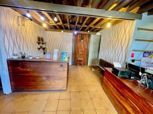 a restaurant with a cash register and a counter at D'Goldwin Lodge in Coron