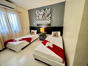a bedroom with two beds and a couch at D'Goldwin Lodge in Coron +1 photo