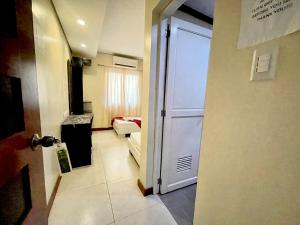 a hallway with a door leading to a living room at D'Goldwin Lodge in Coron