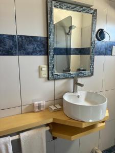a bathroom with a sink and a mirror at Complejo Aguazul in La Pedrera +38 photos