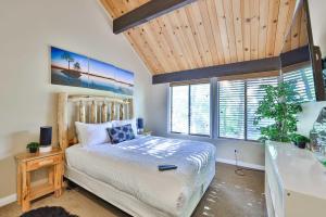 a bedroom with a bed and a wooden ceiling at Spa Steps to Lift Private Spa BBQ Massage Chair in Big Bear Lake