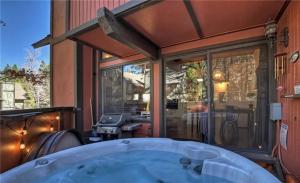 a large bath tub in front of a house at Spa Steps to Lift Private Spa BBQ Massage Chair in Big Bear Lake