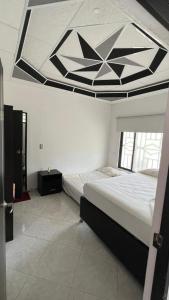 a bedroom with a large bed with a large ceiling at Finca Turística VILLA NELLA in Acacías +6 photos