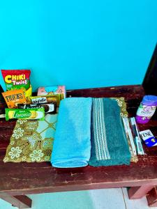 a table with two towels and other snacks on it at Kopinka in Yogyakarta
