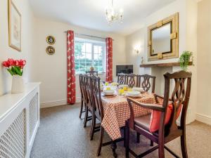 a kitchen and dining room with a table and chairs at Halls Bank Farm in Plumbland