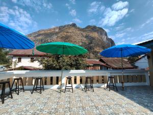 a group of chairs and umbrellas on a roof at Nongkhiaw Chansai Guesthouse in Nongkhiaw