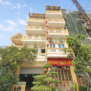 a hotel building with a crane in front of it at Phúc Lộc Hotel Ninh Bình in Ninh Binh