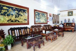 a room with antique furniture and paintings on the walls at Phúc Lộc Hotel Ninh Bình in Ninh Binh