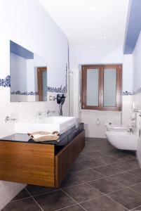 a bathroom with a tub and a toilet and a sink at Residence Corona Grossa in Ciriè