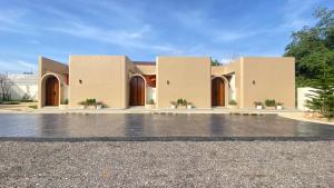 a large house with brown doors on a driveway at Mermayda pool villa hatyai -เมอเมดา in Hat Yai