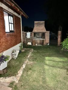 a backyard at night with a brick house at Cabaña petiza in Mina Clavero +3 photos