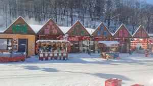 a store with christmas decorations in the snow at Snow Valley Xishui Dragon Soaring Inn in Wuchang