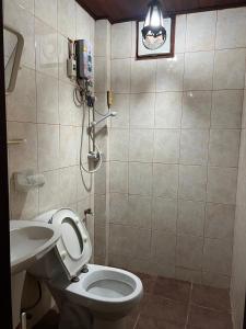 a bathroom with a toilet and a sink at Mary's House Xiengthong in Luang Prabang