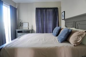 a bedroom with a large white bed with blue pillows at Beach, Please MX in Puerto Peñasco +34 photos