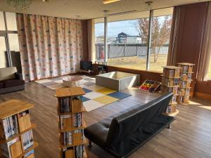 a living room with a couch and a large window at Hotel Kadoman in Aso +36 photos