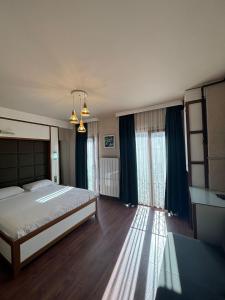 a bedroom with a large bed and some windows at Mezzo Hotel in Istanbul
