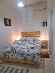 a bed in a bedroom with two lights on at Garden of Chios - Mosaic in Chios