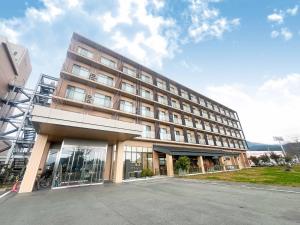 a large building with a lot of windows at Hotel Kadoman in Aso