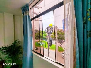 a window with a view of a street at Adel 2 Ovalo Larco Departamento in Trujillo