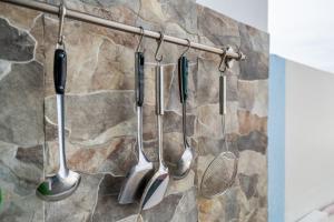 a group of kitchen utensils hanging on a wall at The Twenty Eight in Ungasan +49 photos