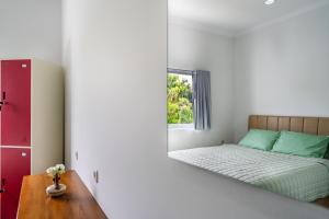 a bedroom with a bed and a mirror at The Twenty Eight in Ungasan