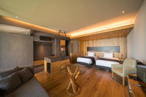 a hotel room with two beds and a couch at SEKIYA RESORT Galleria Midobaru in Beppu