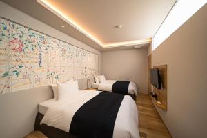 a hotel room with two beds and a large map on the wall at SEKIYA RESORT Galleria Midobaru in Beppu