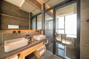 a bathroom with a sink and a mirror at SEKIYA RESORT Galleria Midobaru in Beppu +40 photos