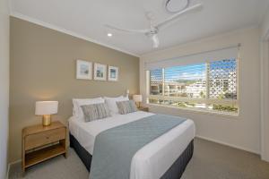a bedroom with a large bed and a window at #2 Hastings Street in Noosa Heads