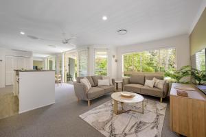 a living room with two couches and a table at #2 Hastings Street in Noosa Heads +73 photos