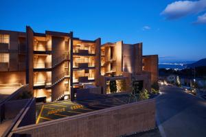 a building at night with the lights on at SEKIYA RESORT Galleria Midobaru in Beppu