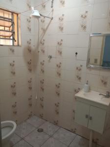 a bathroom with a toilet and a sink at Chácara Seu Antônio in Mombuca +10 photos