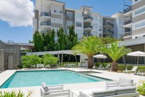 an image of a swimming pool in front of a building at Boulevard North Lakes in North Lakes