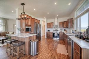 a large kitchen with wooden cabinets and a large island at 2 BR King Bed Hot Tub AC Near Jackson in Victor