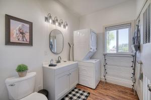 a bathroom with a toilet and a sink and a mirror at 2 BR King Bed Hot Tub AC Near Jackson in Victor +36 photos