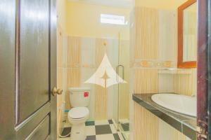 a bathroom with a toilet and a sink at Serey Sok San Apartment in Phumi Ta Phul