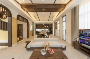 a living room with two beds and a flat screen tv at Hana Village Garden Tropical Bãi Khem in Phú Quốc +165 photos