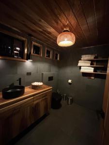 a bathroom with a sink and a toilet in it at Luxury AFrame with Private Jacuzzi Poás Volcano in Vara Blanca +24 photos