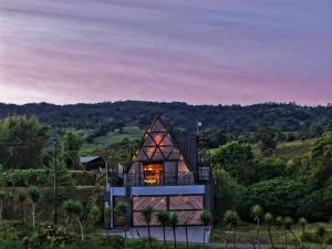a house on a hill with a view at Luxury AFrame with Private Jacuzzi Poás Volcano in Vara Blanca