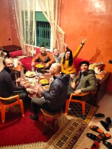 a group of people sitting around a table at chez l'habitant amazigh in Ouarzazate