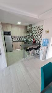 a kitchen with a table and chairs in a room at a SPECIAL place in Los Cristianos +2 photos