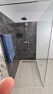 a bathroom with a shower with a blue towel at a SPECIAL place in Los Cristianos