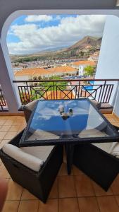 a glass table on a balcony with a view at a SPECIAL place in Los Cristianos