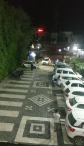 a row of parked cars in a parking lot at night at Hotel Kinara Lodge in Jāmkhed