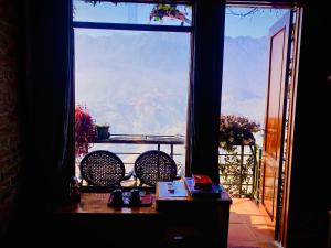 a room with a window with a view of the mountains at Mintu Home in Sapa