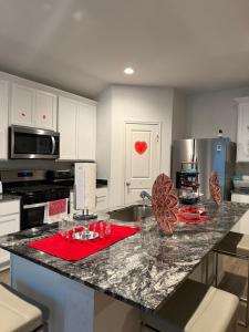 a kitchen with a counter with a red napkin on it at Homely in Richmond