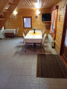 a dining room with a table and chairs in a cabin at Casa Arion in Arieşeni