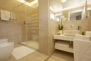 a bathroom with a shower and a toilet and a sink at B&B Mondello Design in Mondello